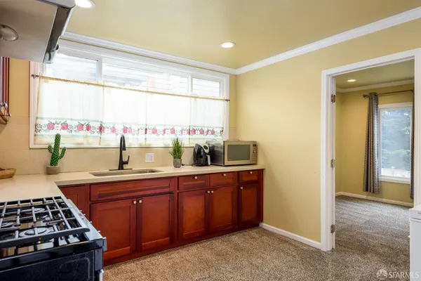 a kitchen with a sink and wooden cabinets
