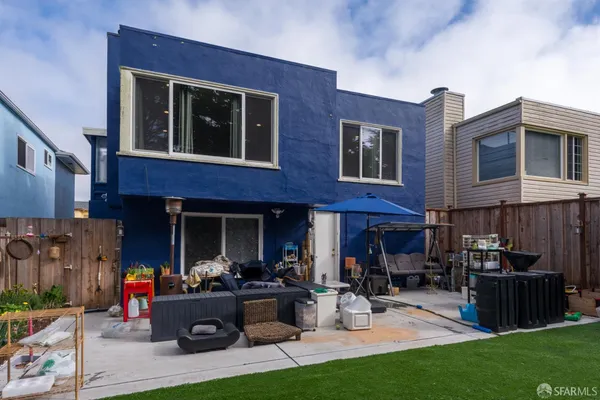 a view of the front of a house with outdoor seating