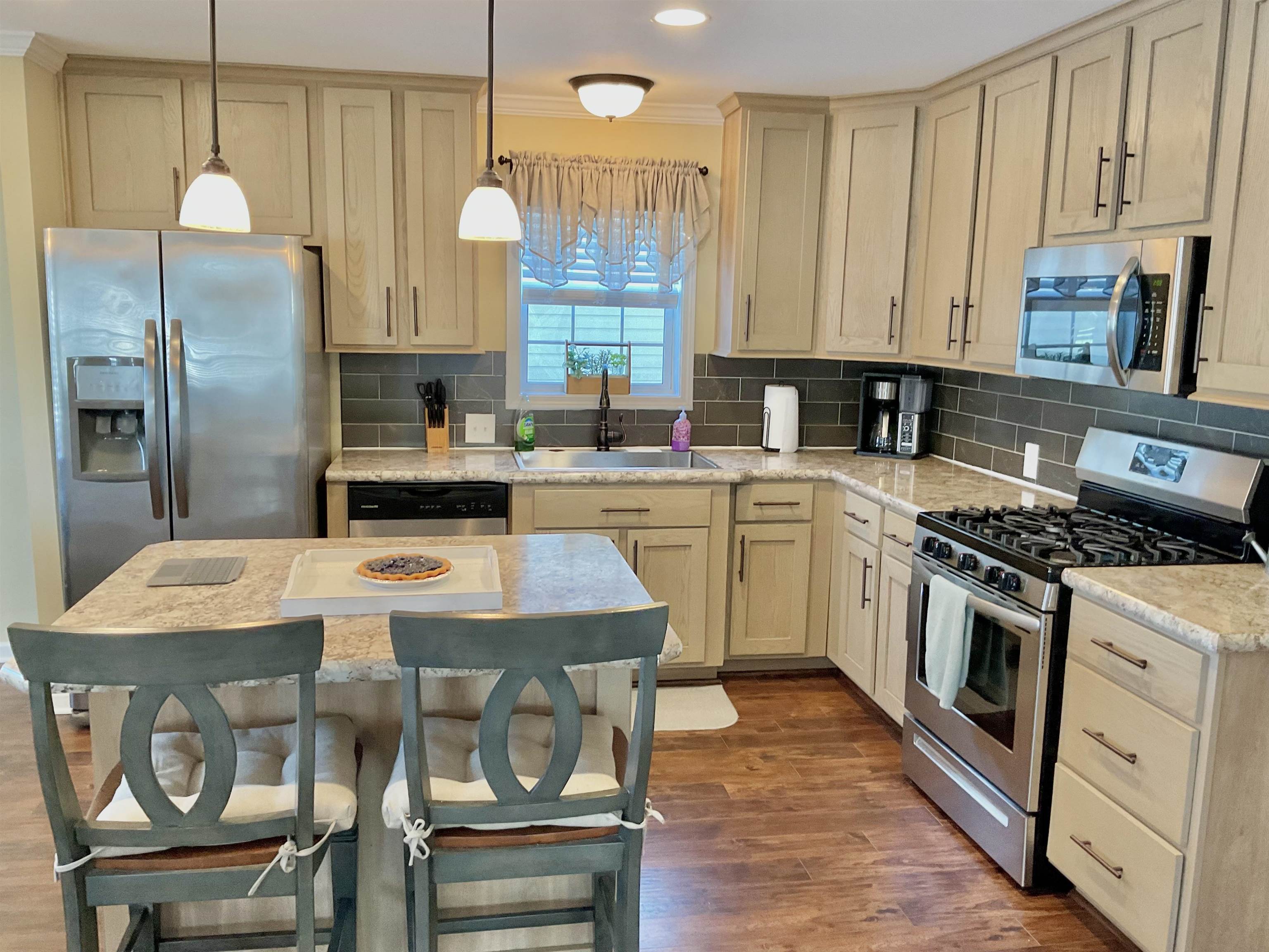 2058 Shore Road Seaville, NJ 08230 - Photo 14 of 36 a kitchen with a stove a sink a refrigerator and chairs