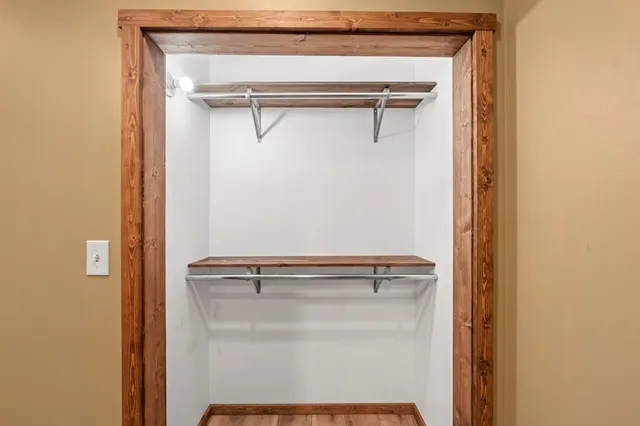 a white bed sitting in a room next to a window