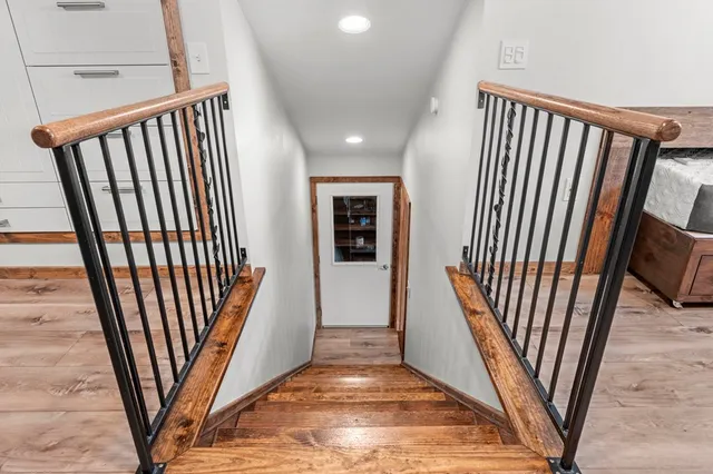a view of hallway with wooden floor