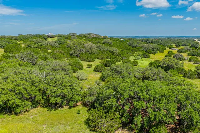 an aerial view of a houses with yard