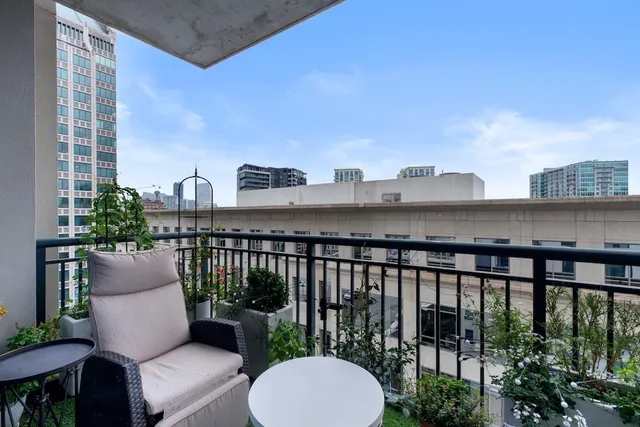 a view of a chairs and table in the balcony