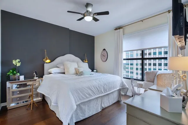 a bedroom with a bed and windows