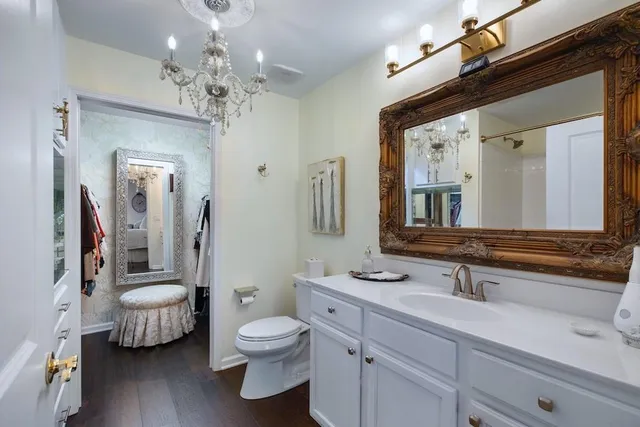 a bathroom with a toilet a sink and mirror