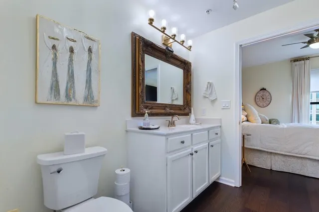 a bathroom with a toilet sink and mirror