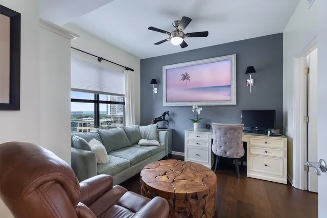 a living room with furniture a ceiling fan and a window