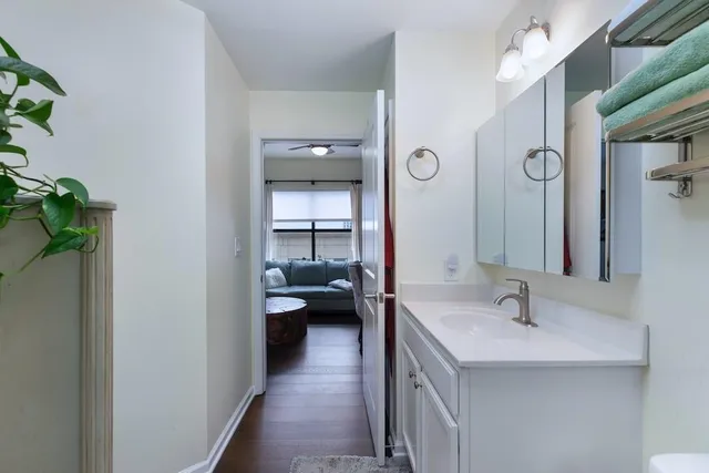 a en suite bathroom with a granite countertop sink and a mirror