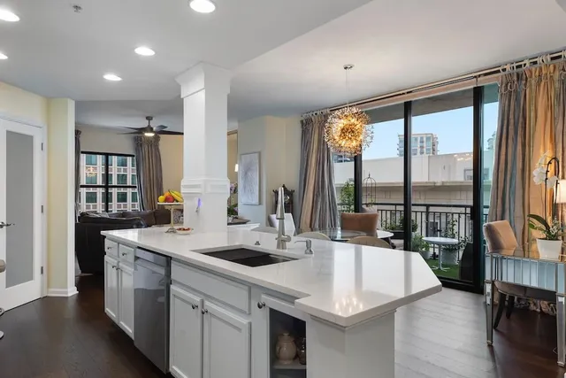 a kitchen with kitchen island a sink and a large window