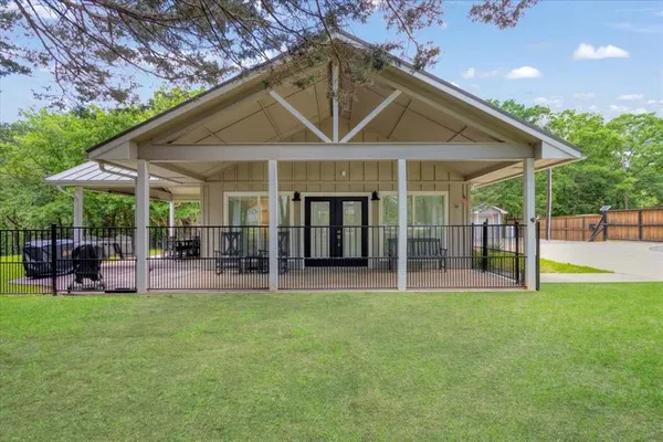 a view of a house with a yard and sitting area