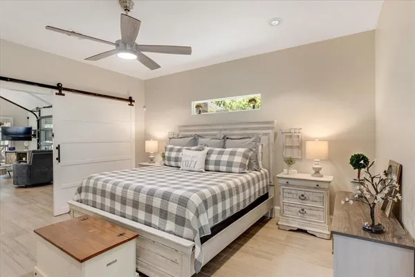a bedroom with a bed and ceiling fan