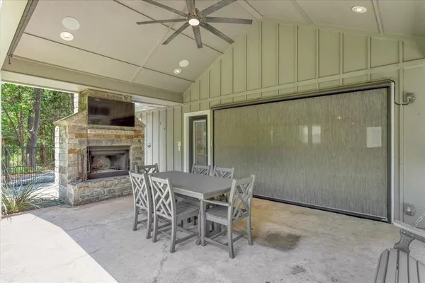 a dining room with furniture a fireplace and wooden floor