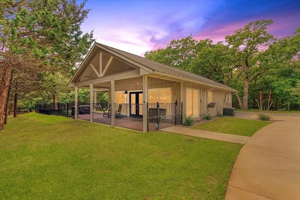 a view of a house with a yard patio and sitting area