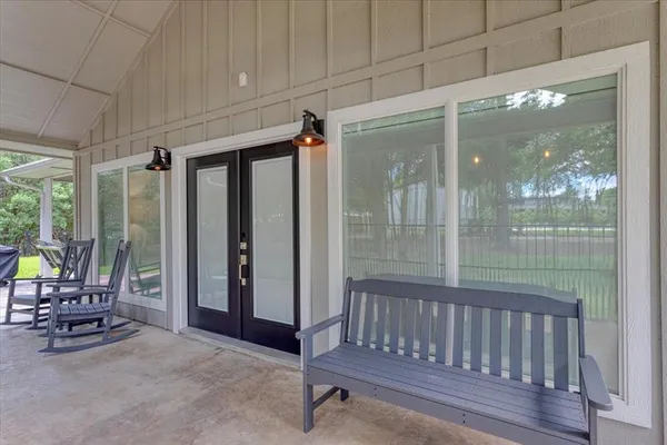 a view of a room with a large window and sitting area