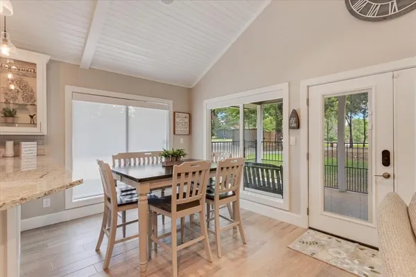 a dining room with furniture wooden floor and a rug