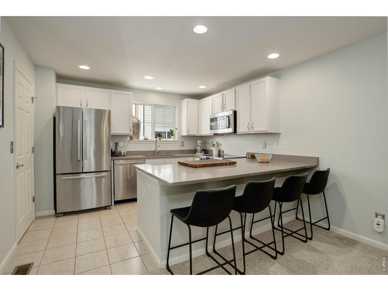 4116 Riley Drive Longmont, CO 80503 - Photo 12 of 33 Updated Kitchen with beautiful quartz countertop that provides additional seating and prep space