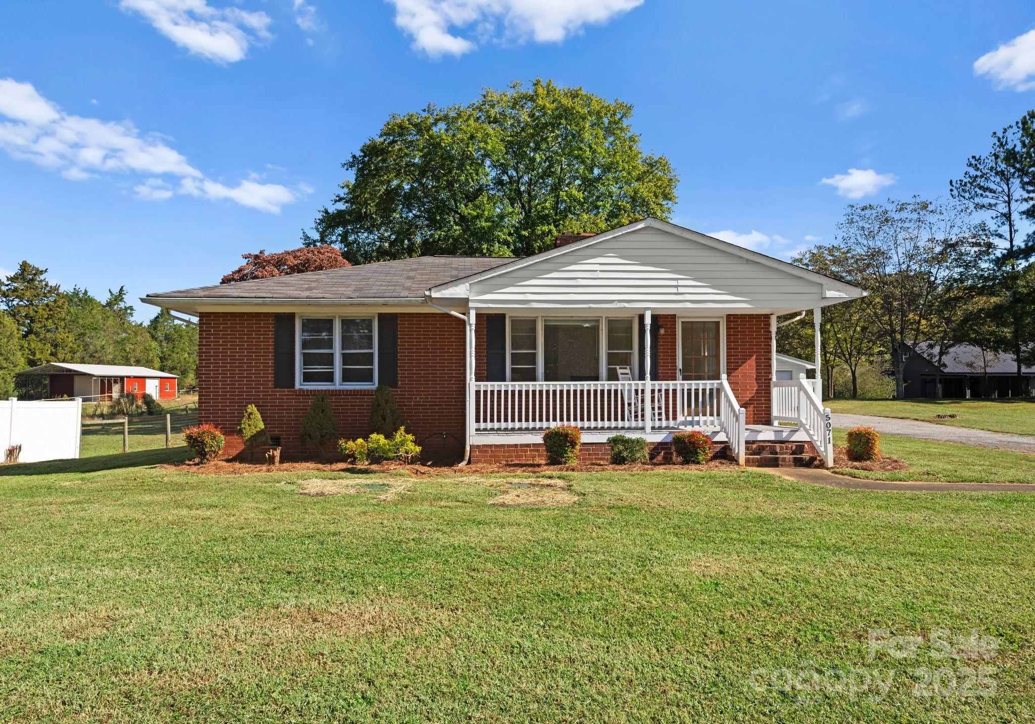 5170 Woodleaf Road Salisbury, NC 28147 - Photo 2 of 13 a front view of a house with a garden and trees