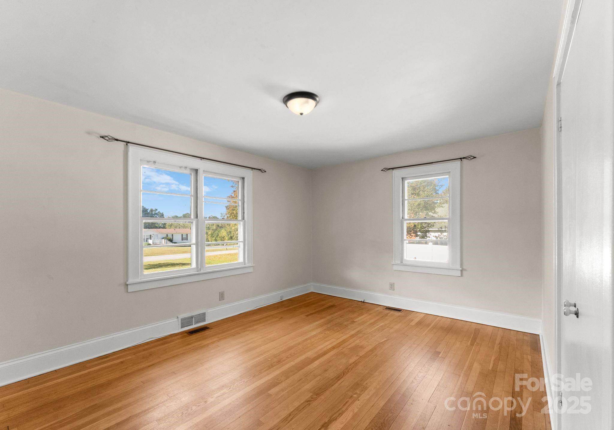 5170 Woodleaf Road Salisbury, NC 28147 - Photo 6 of 13 a view of an empty room with wooden floor and a window