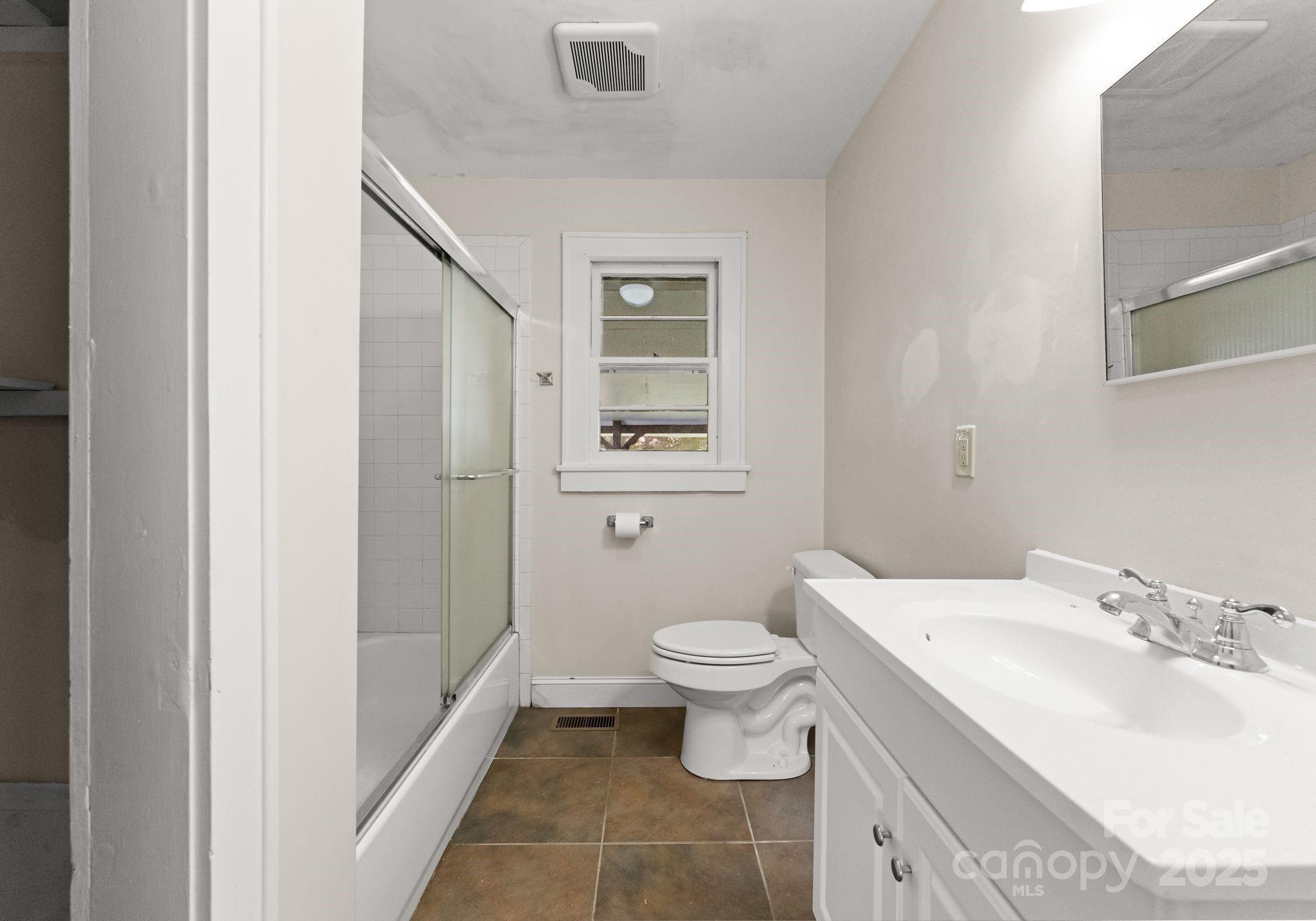 5170 Woodleaf Road Salisbury, NC 28147 - Photo 8 of 13 a bathroom with a sink toilet and shower
