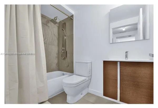 a bathroom with a toilet a sink and shower