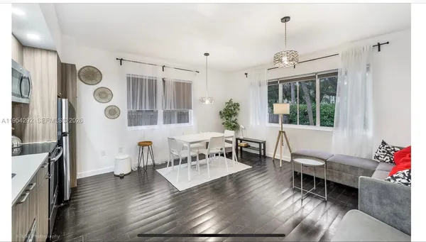 a living room with furniture and wooden floor