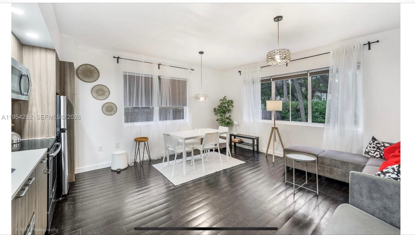 557 Michigan Avenue, Unit 111 Miami Beach, FL 33139 - Photo 6 of 13 a living room with furniture and wooden floor