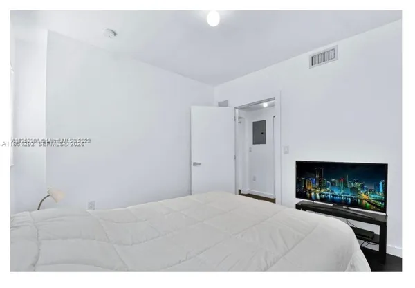 a bedroom with a bed and a fireplace