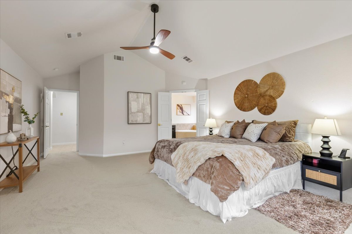 2501 Aspen Meadow Road Leander, TX 78641 - Photo 19 of 30 Expansive room featuring vaulted ceilings, a ceiling fan with integrated lighting, and light-toned carpeting