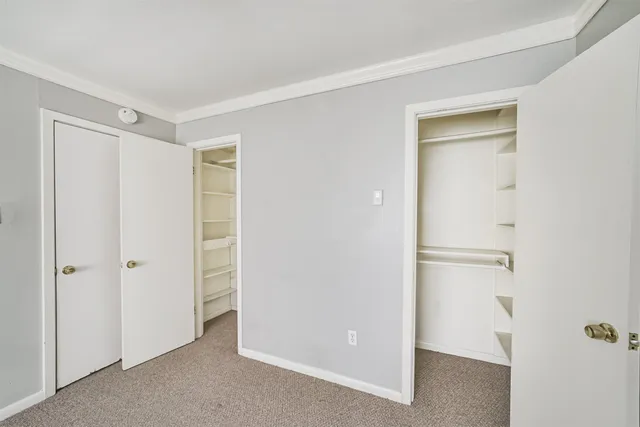 a view of a room with a ceiling fan and a window