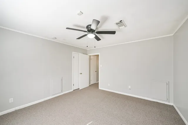 a view of a room with a ceiling fan