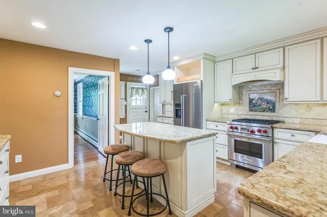 a kitchen with a stove a refrigerator and a sink