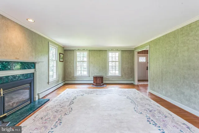 a view of an empty room with a fireplace