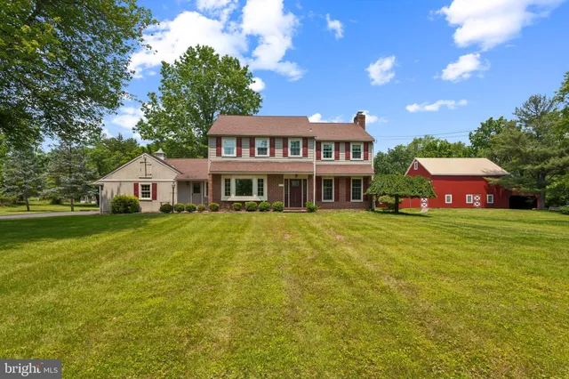a front view of a house with a yard table and chairs