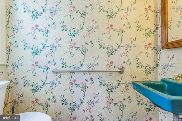 a view of bathroom with a toilet and a shower curtain