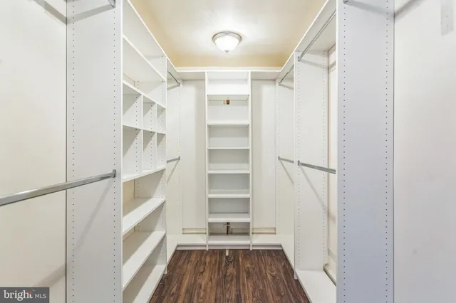 a view of walk in closet with empty racks