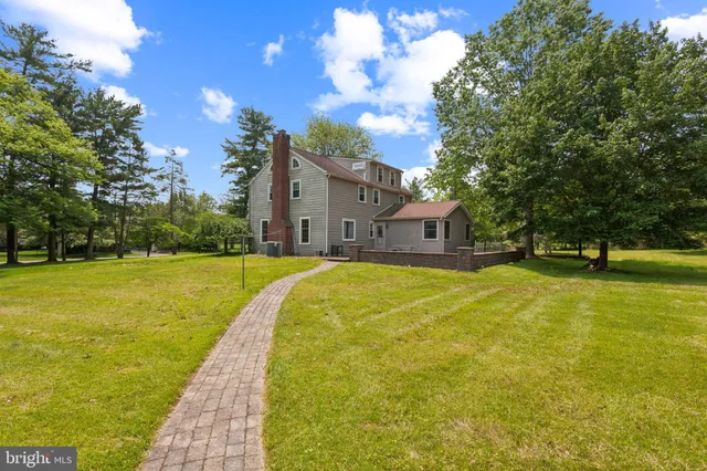 a house view with swimming pool in front of the house