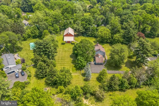 a aerial view of a house with swimming pool and garden