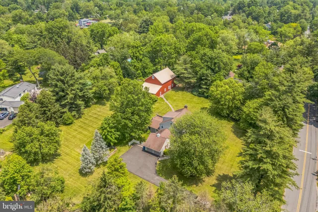 an aerial view of residential house with swimming pool and green space