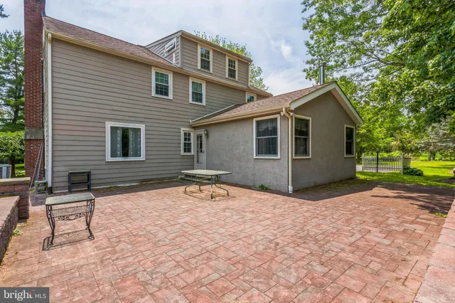 a backyard of a house with yard and outdoor seating