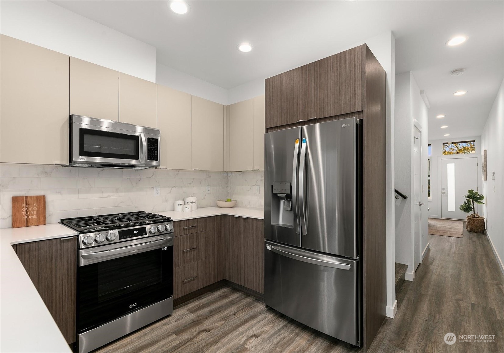 10140 Holman Road Northwest Seattle, WA 98133 - Photo 5 of 16 a kitchen with stainless steel appliances a refrigerator a stove top oven a sink and cabinets