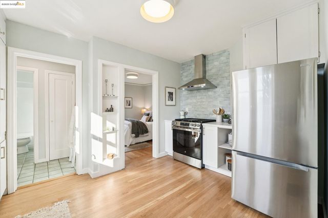 a kitchen with stainless steel appliances a refrigerator and a stove top oven