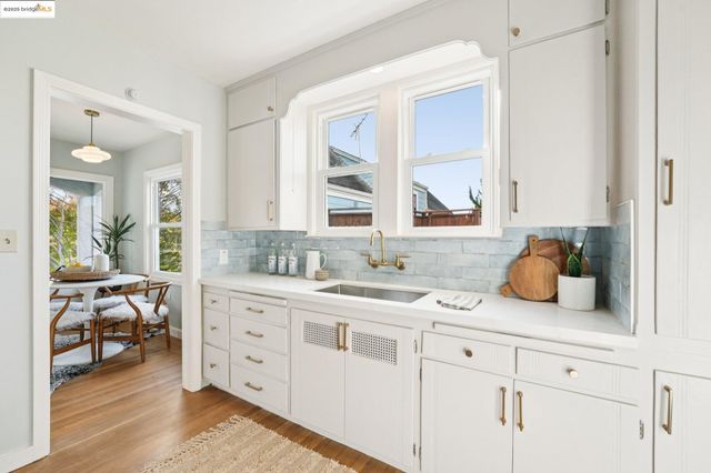 a kitchen with sink and cabinets