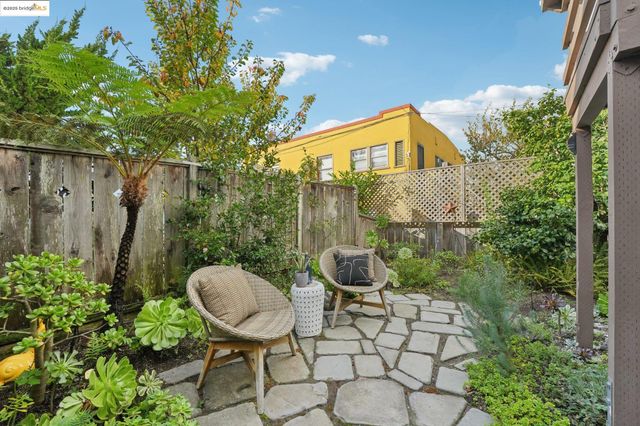 a view of a chair and table in backyard of the house