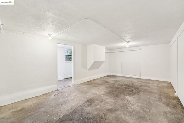 an empty room with an empty space and windows