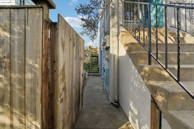 a backyard of a house with table and chairs