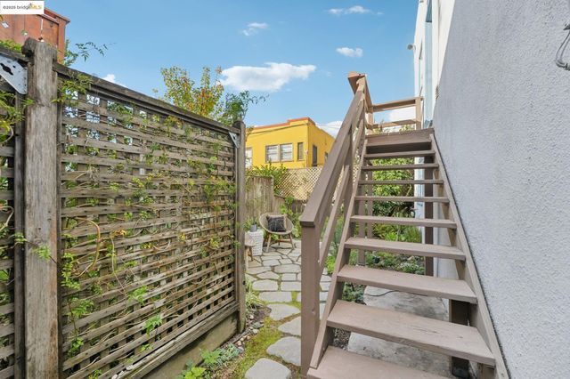 a view of a chairs and table in backyard of the house
