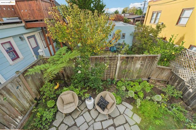a view of a backyard with plants and a fountain