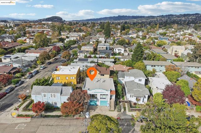 an aerial view of a house with a yard garage and lake view