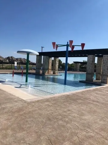 a view of a swimming pool with a couple of people