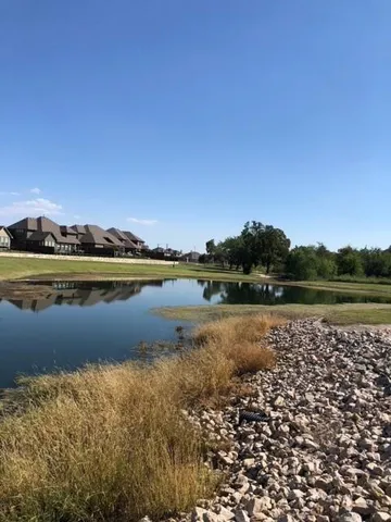 a view of a lake with houses in the back